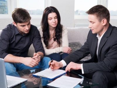 Agent advises the couple, signing documents